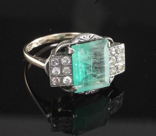 An Art Deco 18ct gold and platinum, emerald and diamond dress ring, size R.